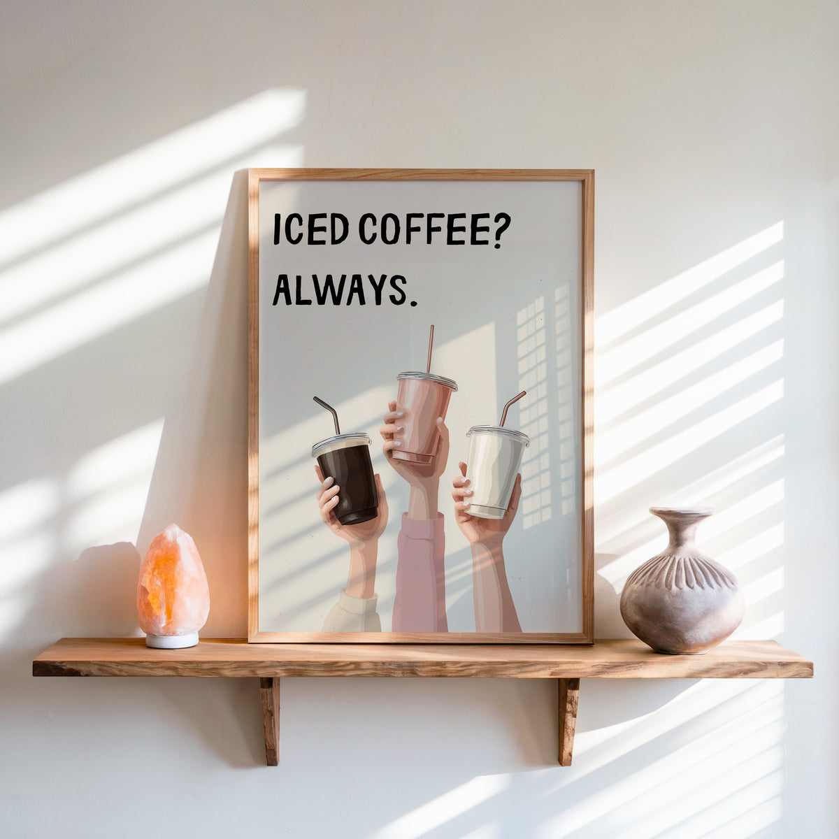 Iced Coffee Always print in an oak frame on a live-edge shelf beside a salt lamp