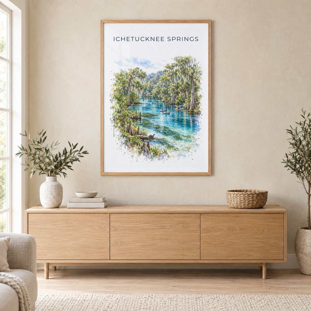 Ichetucknee Springs State Park watercolor print in an oak frame above a light wood sideboard in a Scandinavian living room