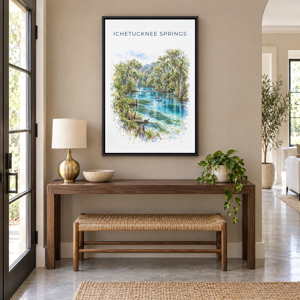 Ichetucknee Springs State Park watercolor as a black floater canvas above a walnut console and woven bench in an entryway
