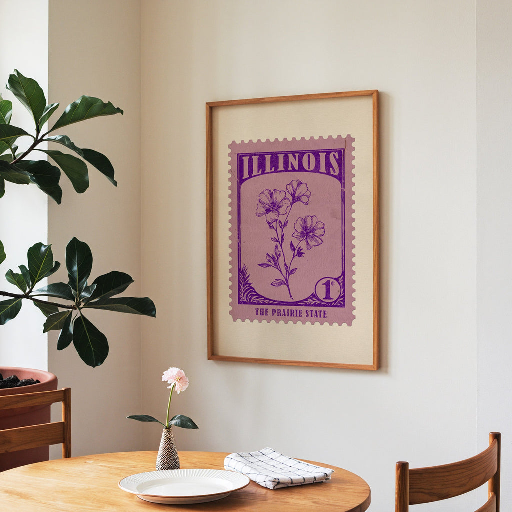 Illinois state flower print framed above a round wooden table with a single bloom in a vase and books