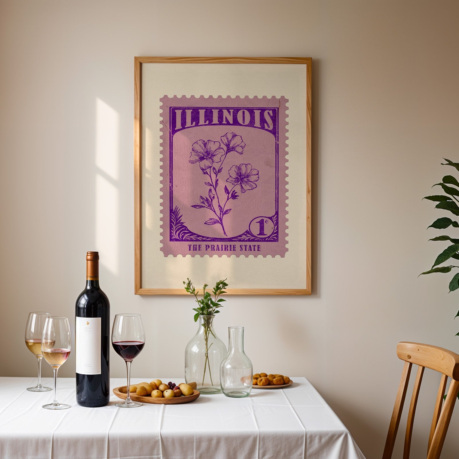 Illinois stamp print framed on the wall above a dining table set with wine, glasses and olives
