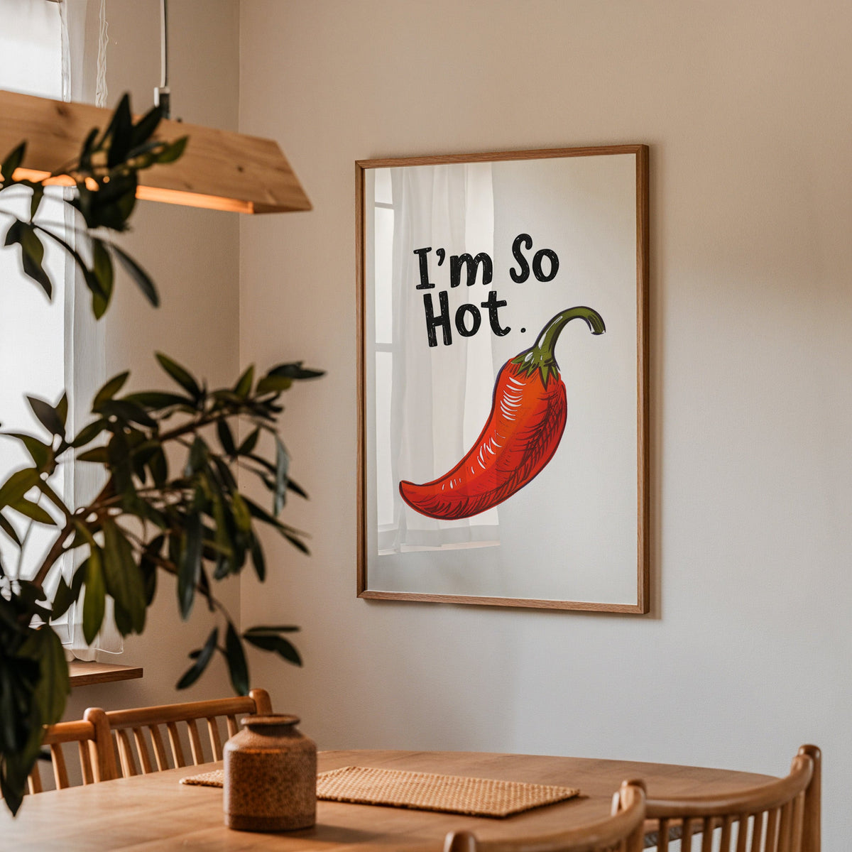 I'm So Hot chilli print in a walnut frame above a dining table with olive branches