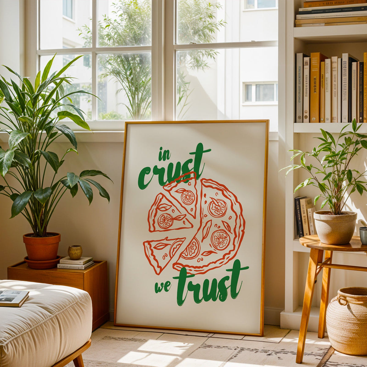 Pizza poster in a slim brass frame resting on a berber rug in a plant-filled living room