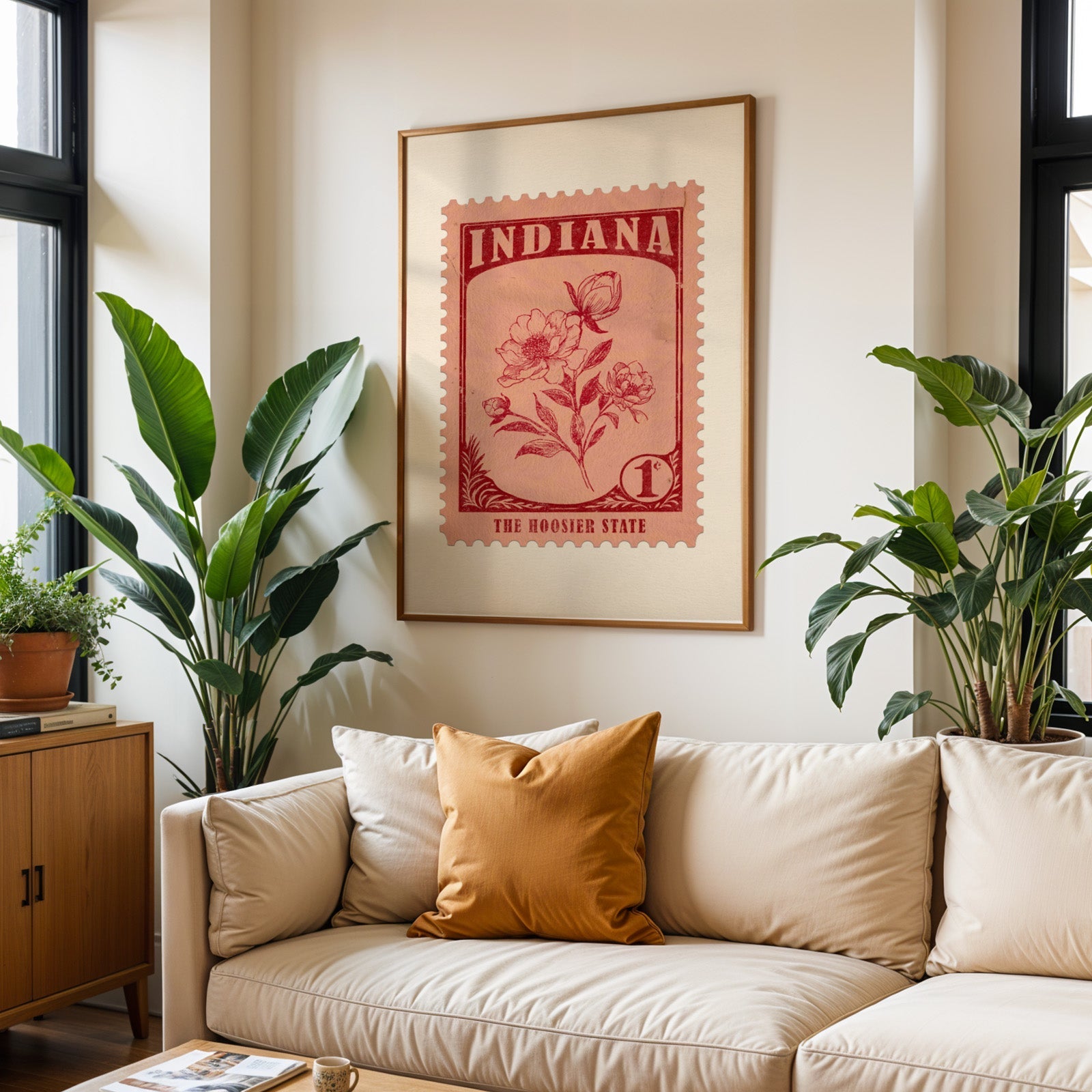 Indiana state flower print framed above a cream sofa with an ochre cushion and large plants either side