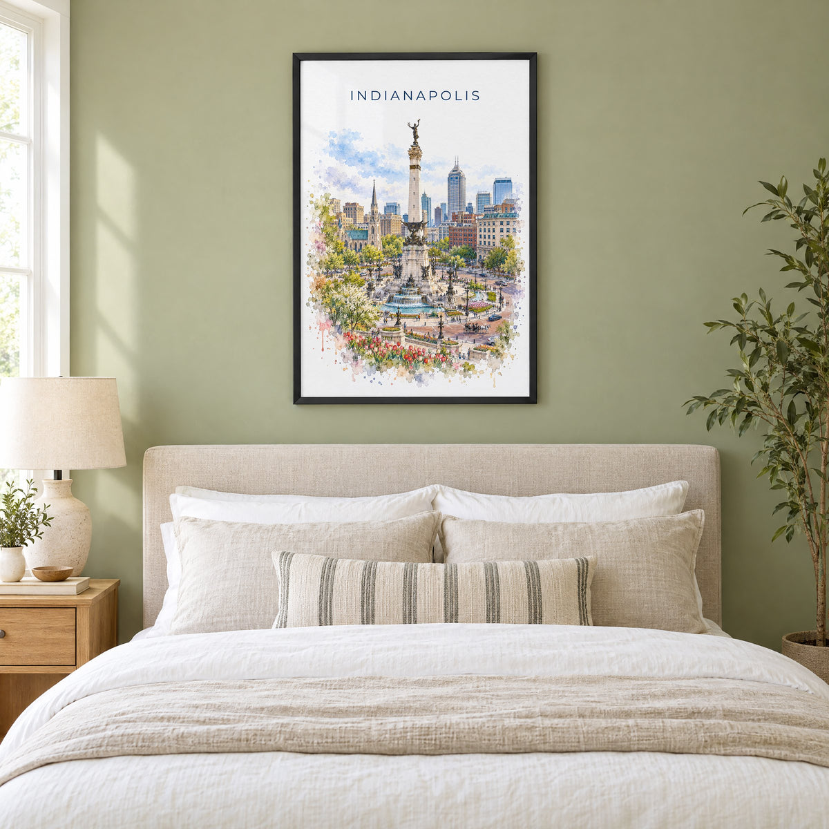 Indianapolis watercolor print in a black frame above an upholstered headboard in a sage green bedroom