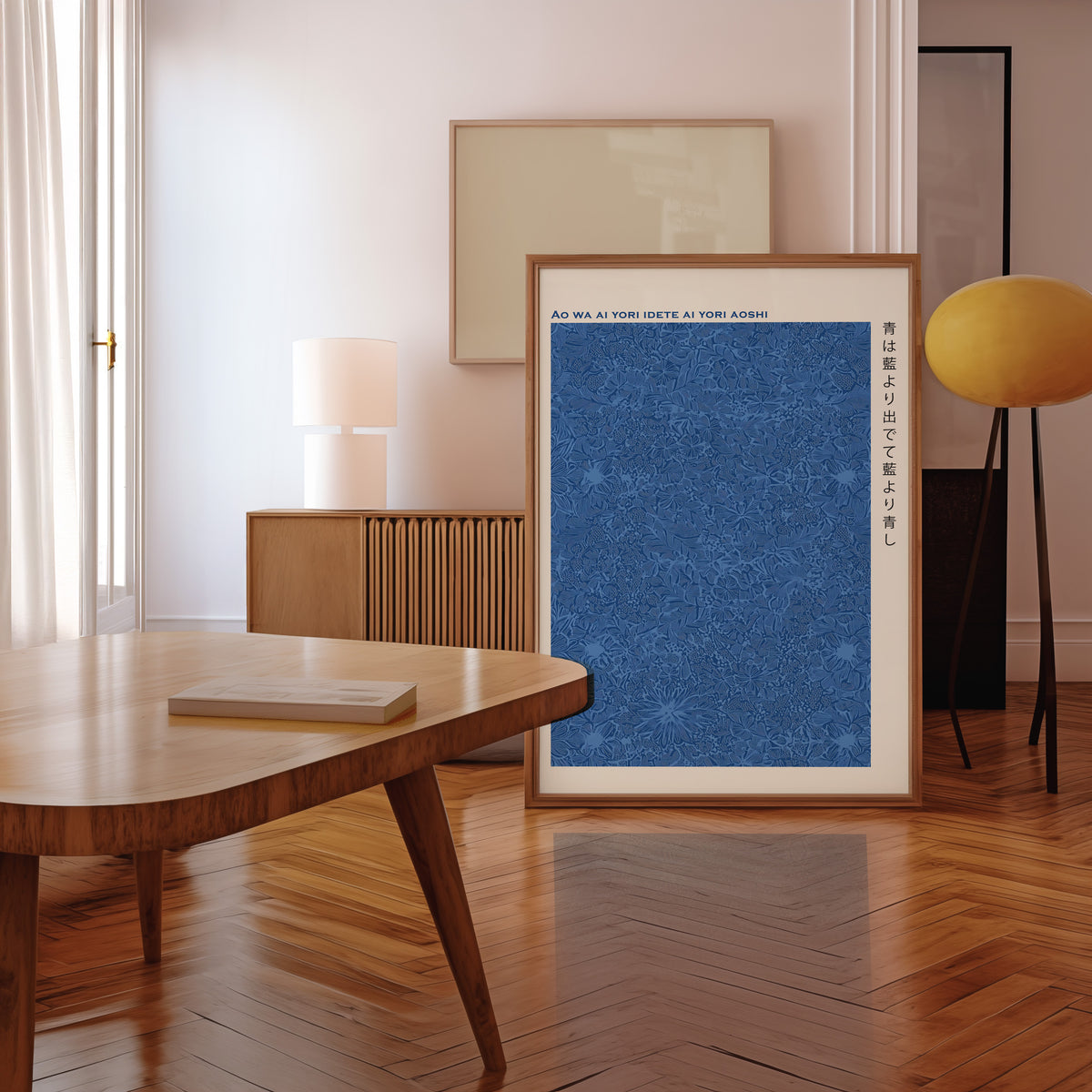Indigo pattern Japanese proverb print in a walnut frame leaning in a mid-century living room