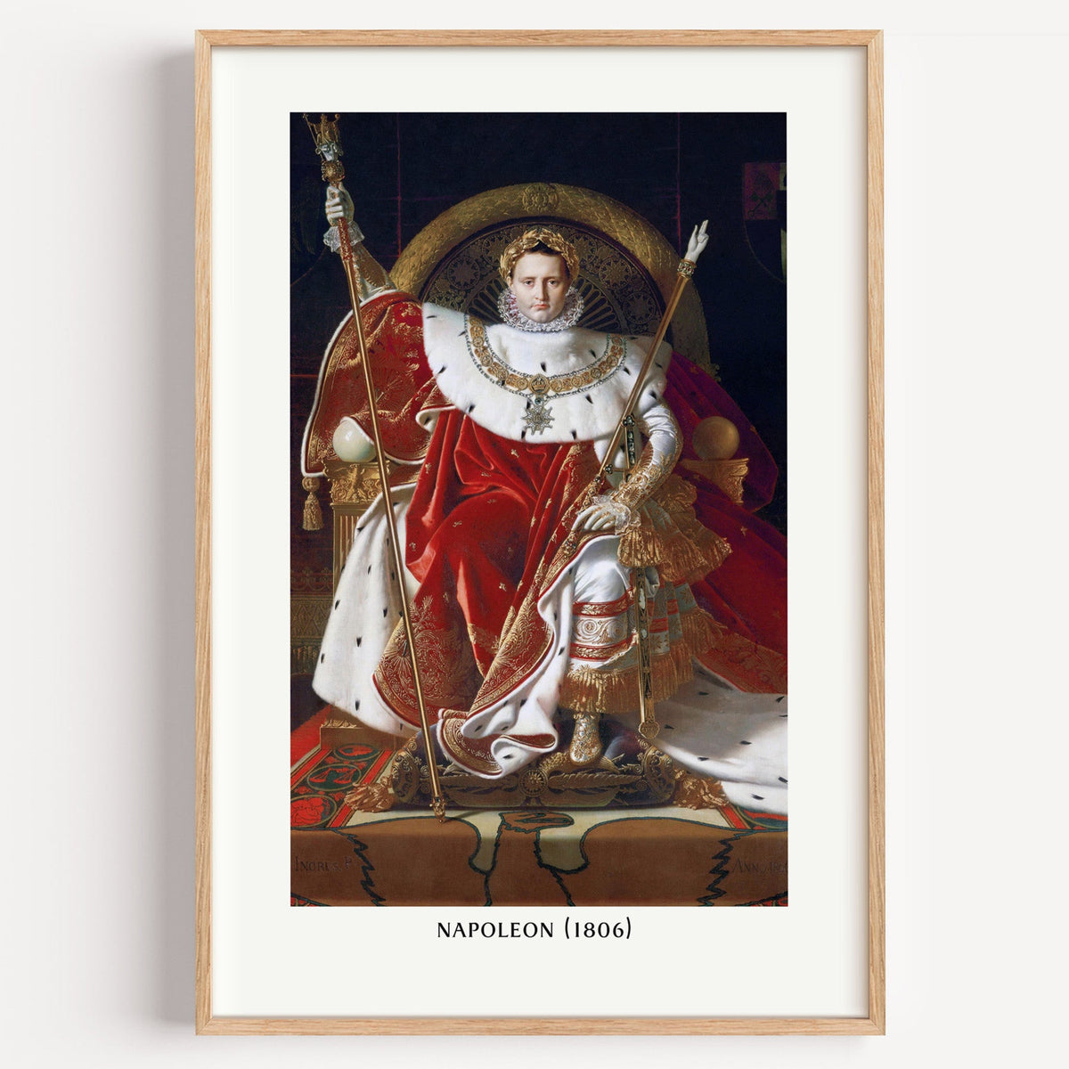 Ingres Napoleon portrait print in a light oak frame on a white wall