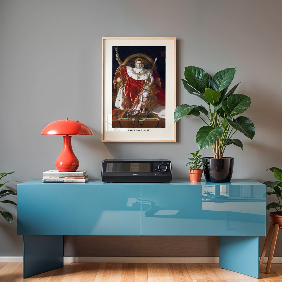 Napoleon print in an oak frame above a teal sideboard with a red lamp