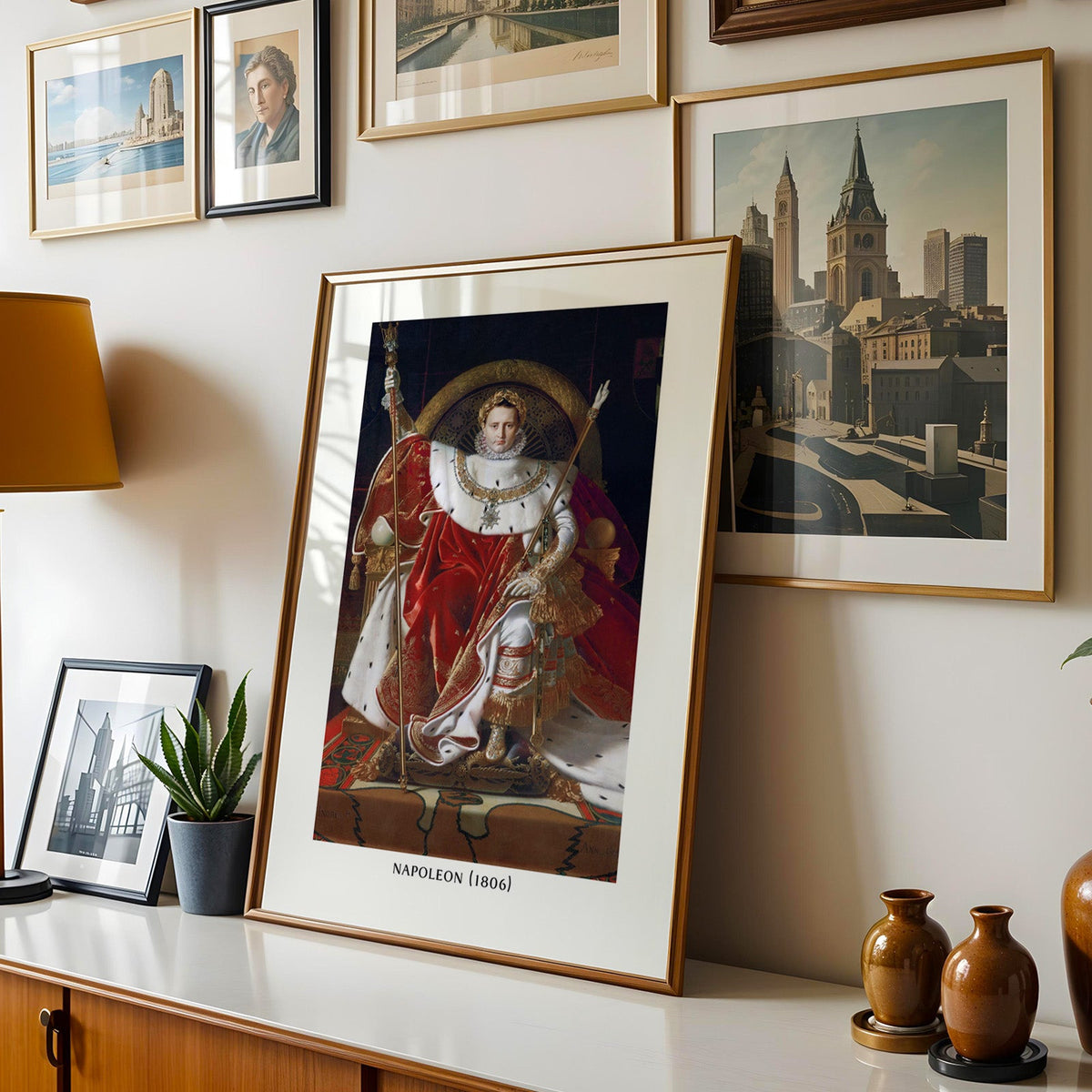 Ingres portrait print shown in a gold frame leaning on a sideboard in a gallery wall