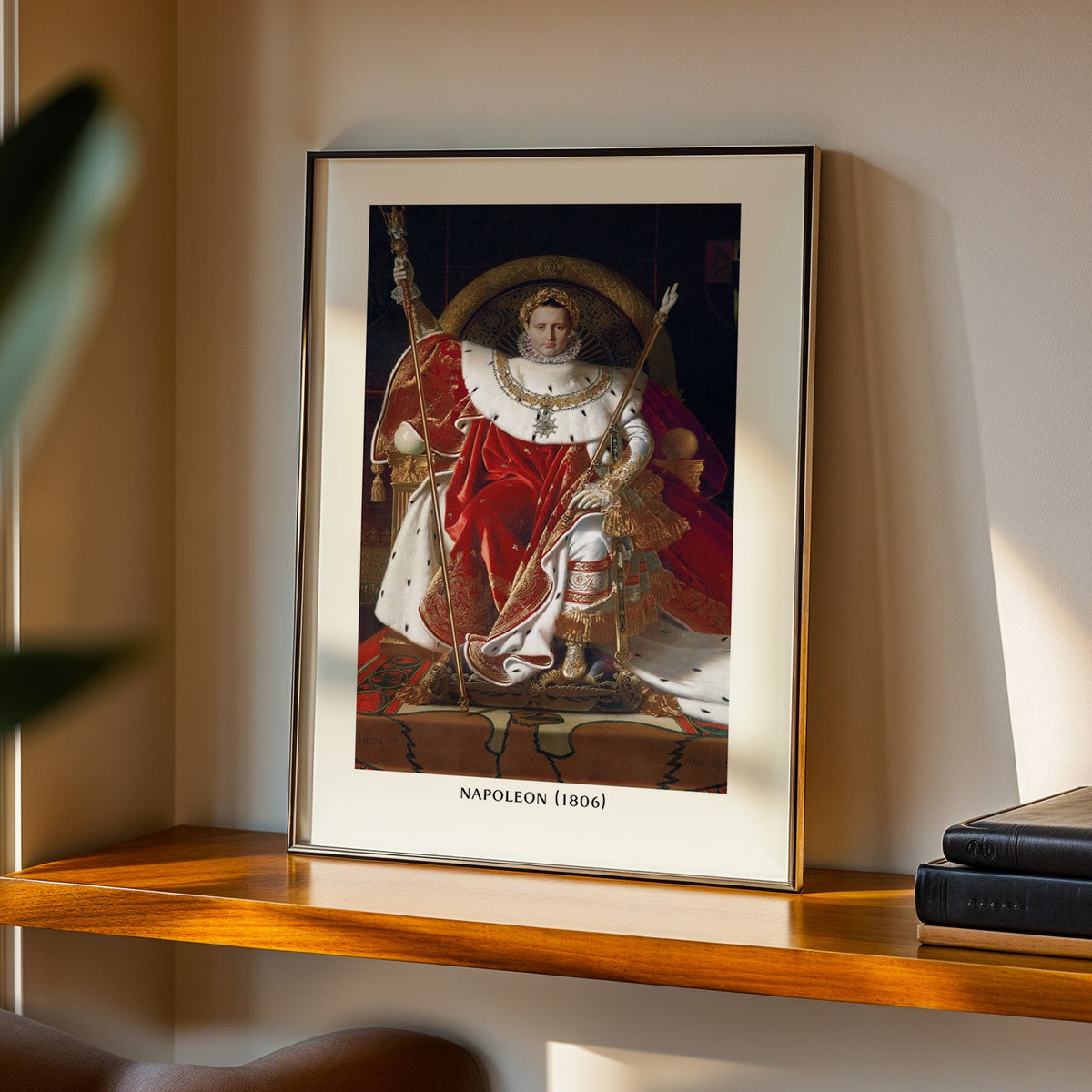 Napoleon enthroned print in a black frame on a walnut shelf in evening light