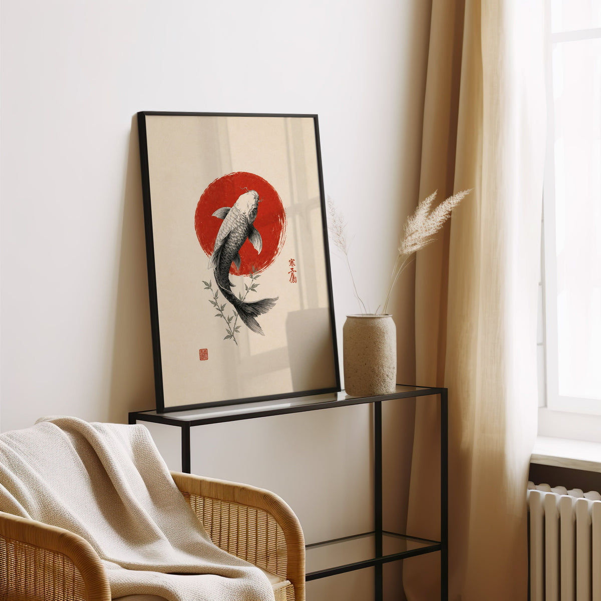 ink koi fish in red circle print in a black frame leaning on a glass console beside pampas grass