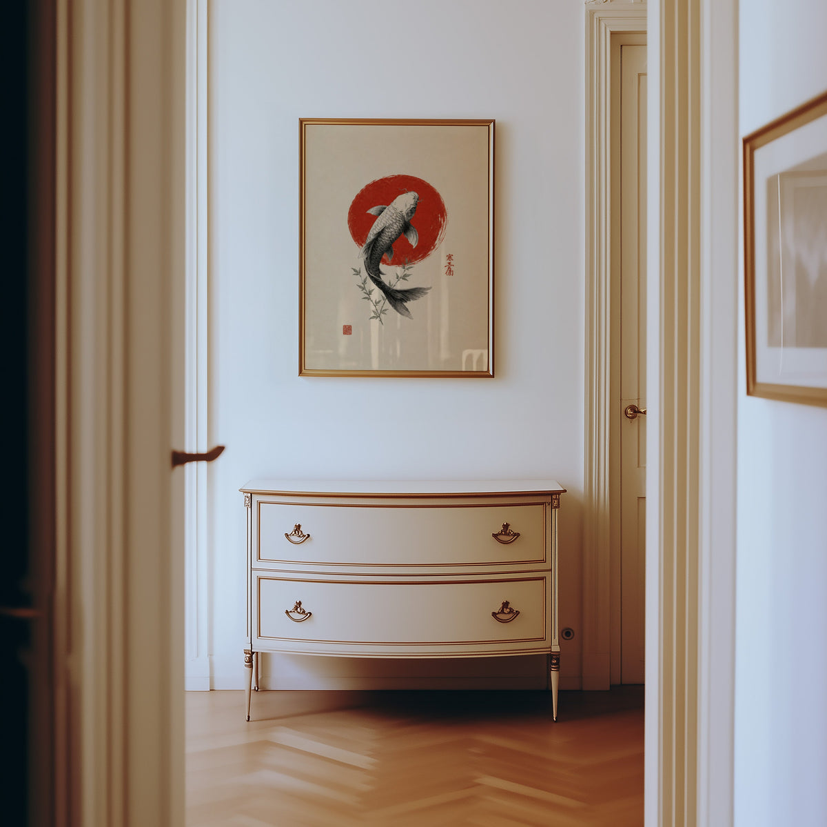 ink koi fish in red circle print shown in a gold frame in a hallway above a cream dresser