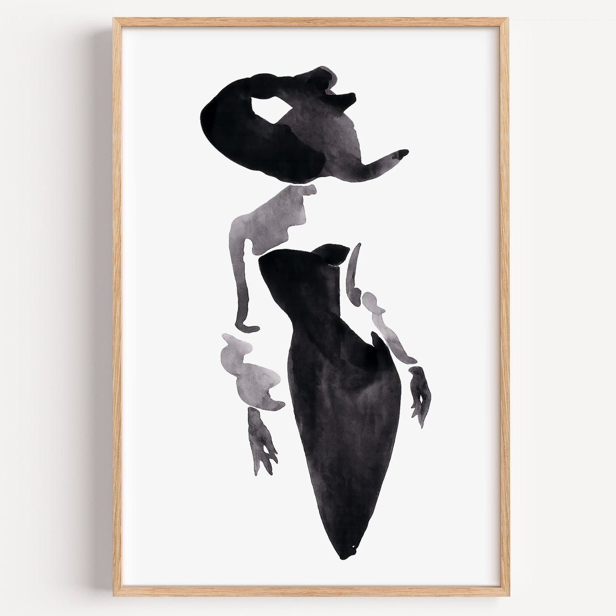 Ink wash woman in fitted black dress print in a light oak frame on a plain white wall