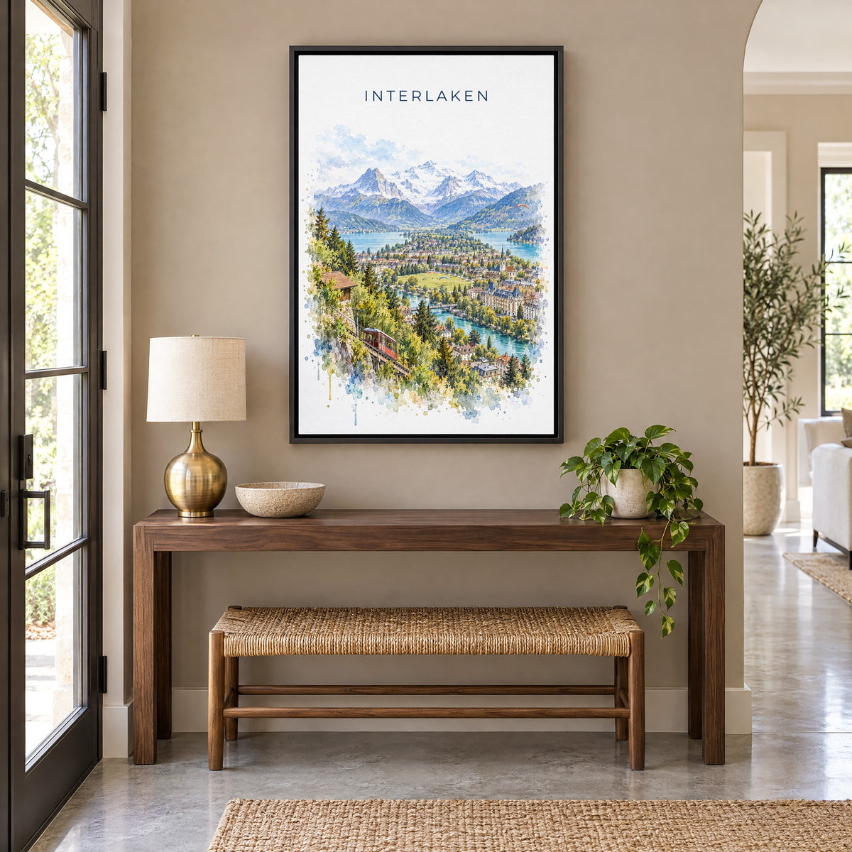 Interlaken watercolor print as a black floater canvas above a walnut console and woven bench in an entryway