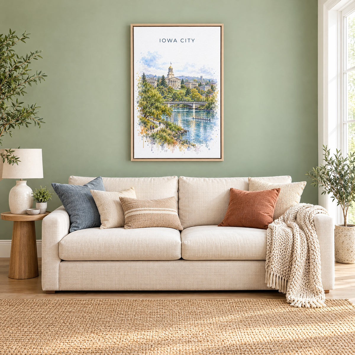 Iowa City watercolor print as a natural floater canvas above a cream linen sofa on a sage green wall