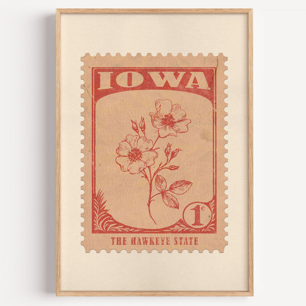 Iowa state flower stamp print in brick red on peach, light oak frame on a plain white wall