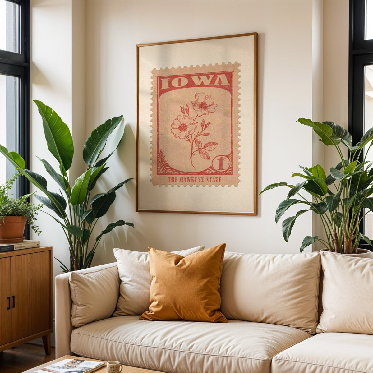 Iowa state flower print framed above a cream sofa with an ochre cushion and large plants either side