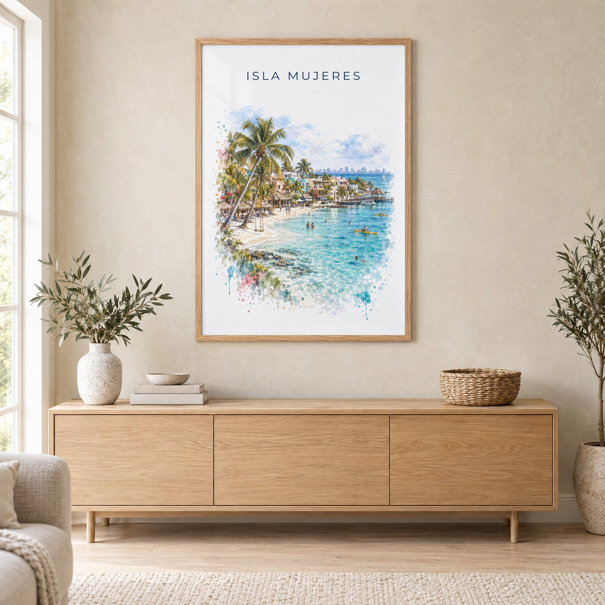 Isla Mujeres watercolor print in an oak frame above a light wood sideboard in a Scandinavian living room