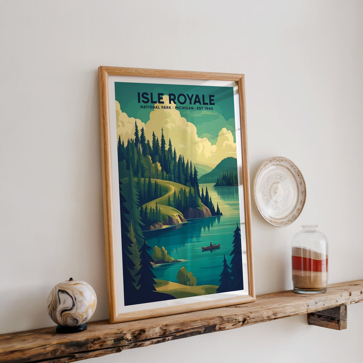 Isle Royale National Park print in an oak frame on a rustic wood shelf with ceramics and a sand-filled jar