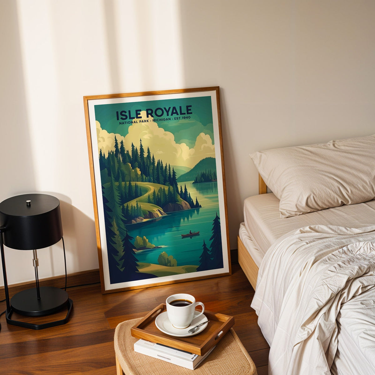 Isle Royale National Park print in an oak frame leaning on a bedroom floor beside the bed and a coffee tray