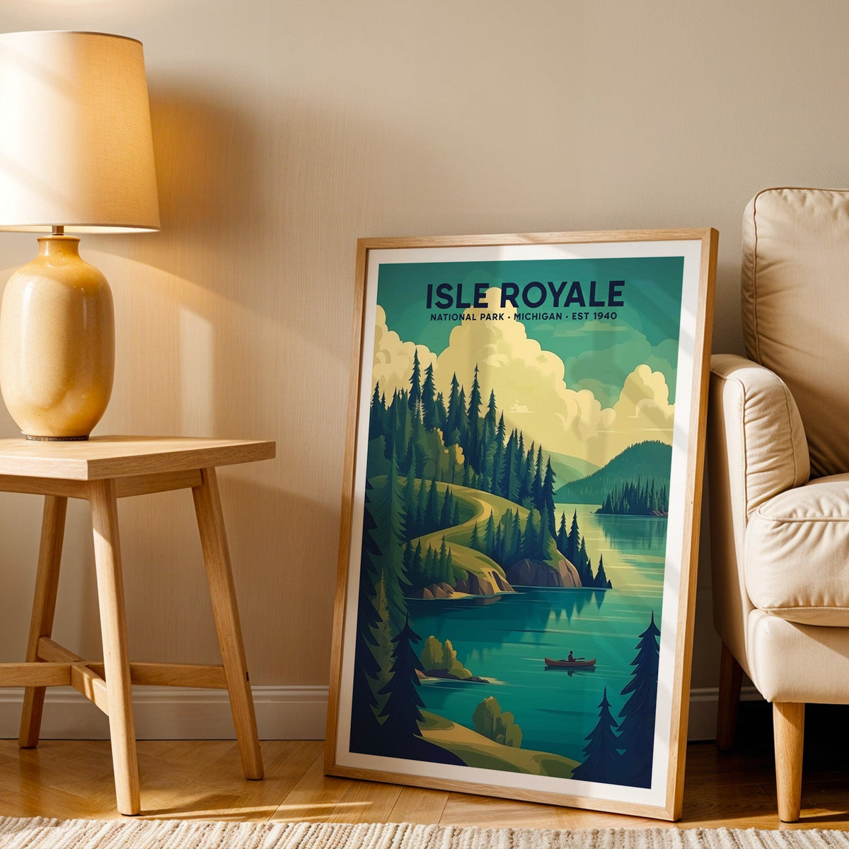 Isle Royale print in an oak frame beside a cream armchair and an amber lamp in warm afternoon light