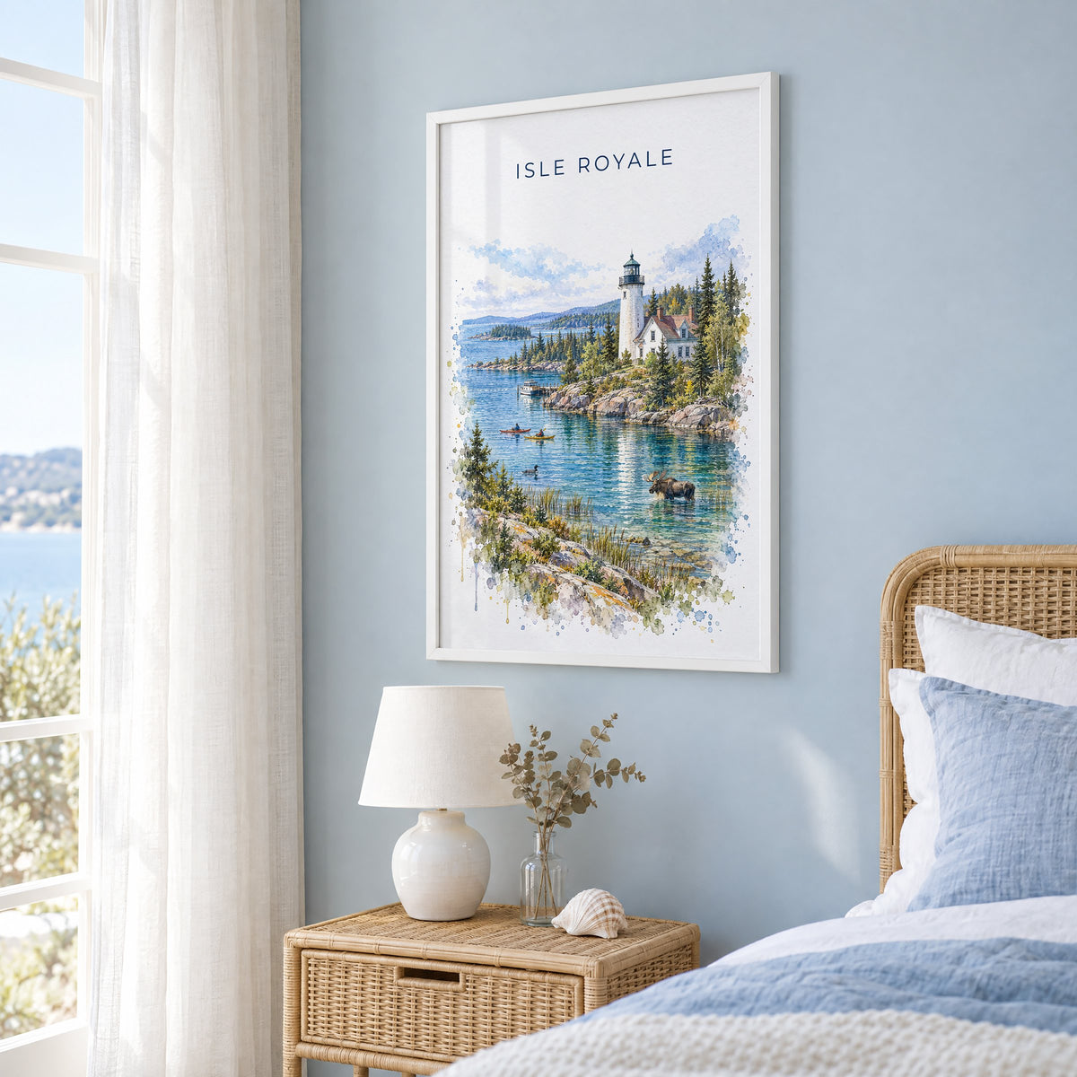Isle Royale National Park watercolor print in a white frame on a pale blue wall beside a rattan bed in a coastal bedroom