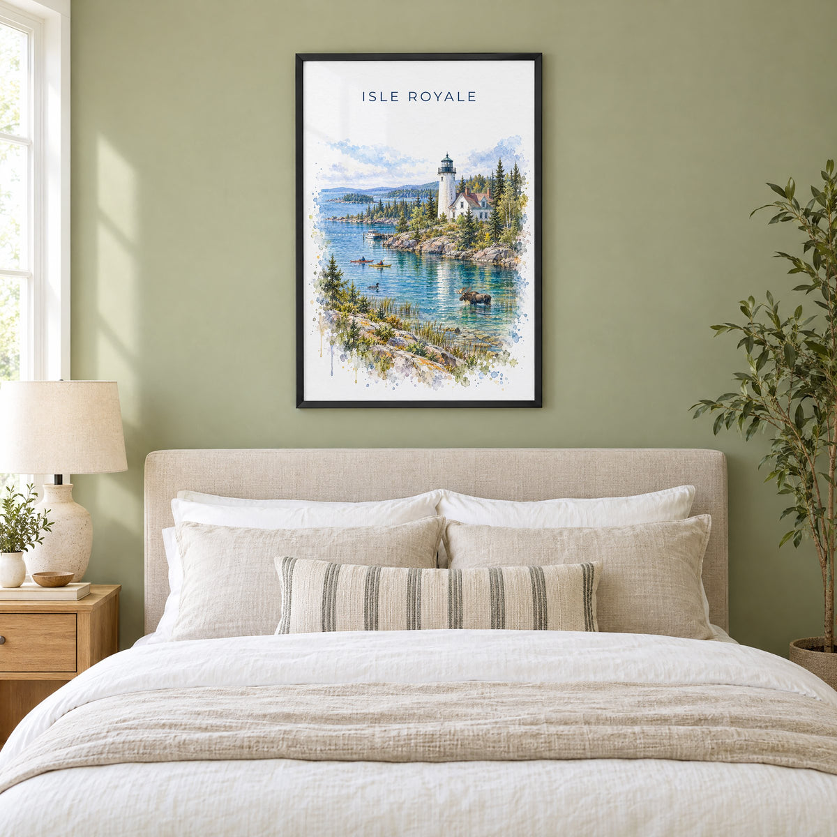 Isle Royale National Park watercolor print in a black frame above an upholstered headboard in a sage green bedroom