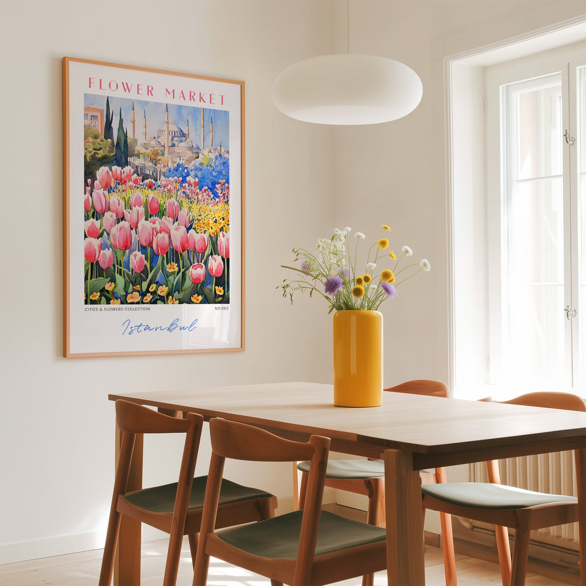 Istanbul flower market print in an oak frame above a dining table with a yellow vase and white pendant light