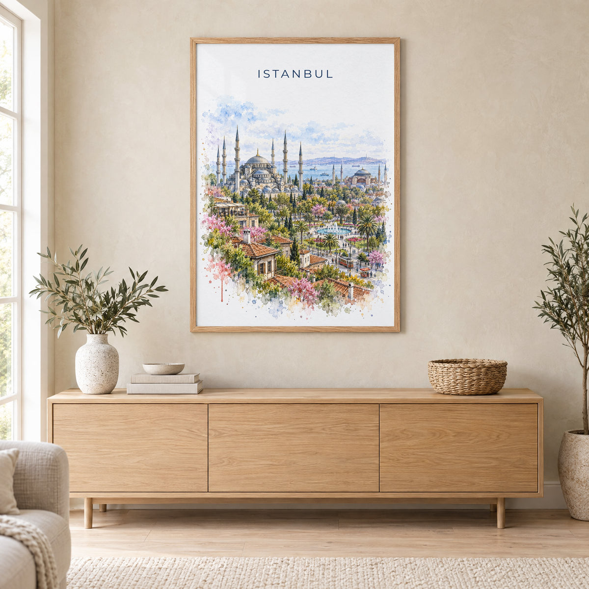 Istanbul watercolor print in an oak frame above a light wood sideboard in a Scandinavian living room