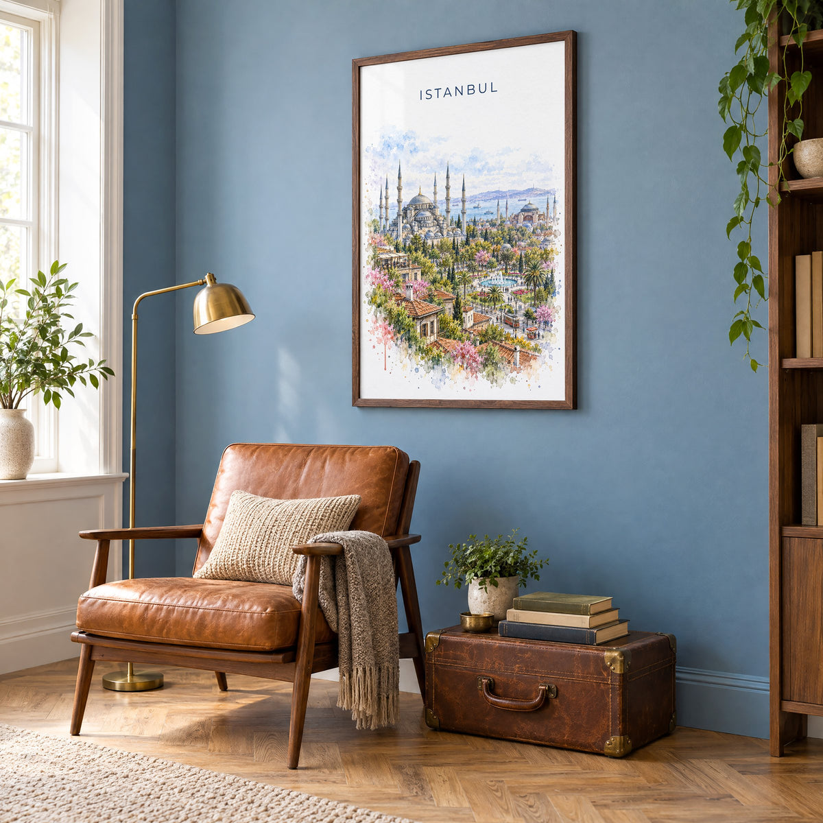 Istanbul watercolor print in a walnut frame on a blue wall above a leather armchair in a reading nook