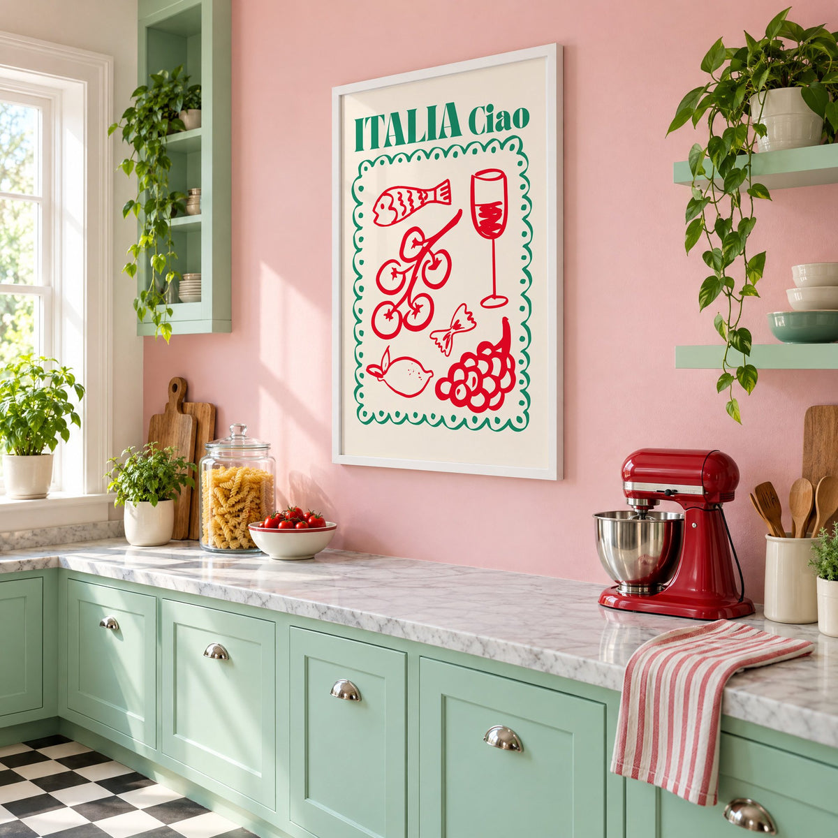 ITALIA Ciao red food doodles print in a white frame on a pink wall above mint green cabinets in a retro kitchen, seen at an angle