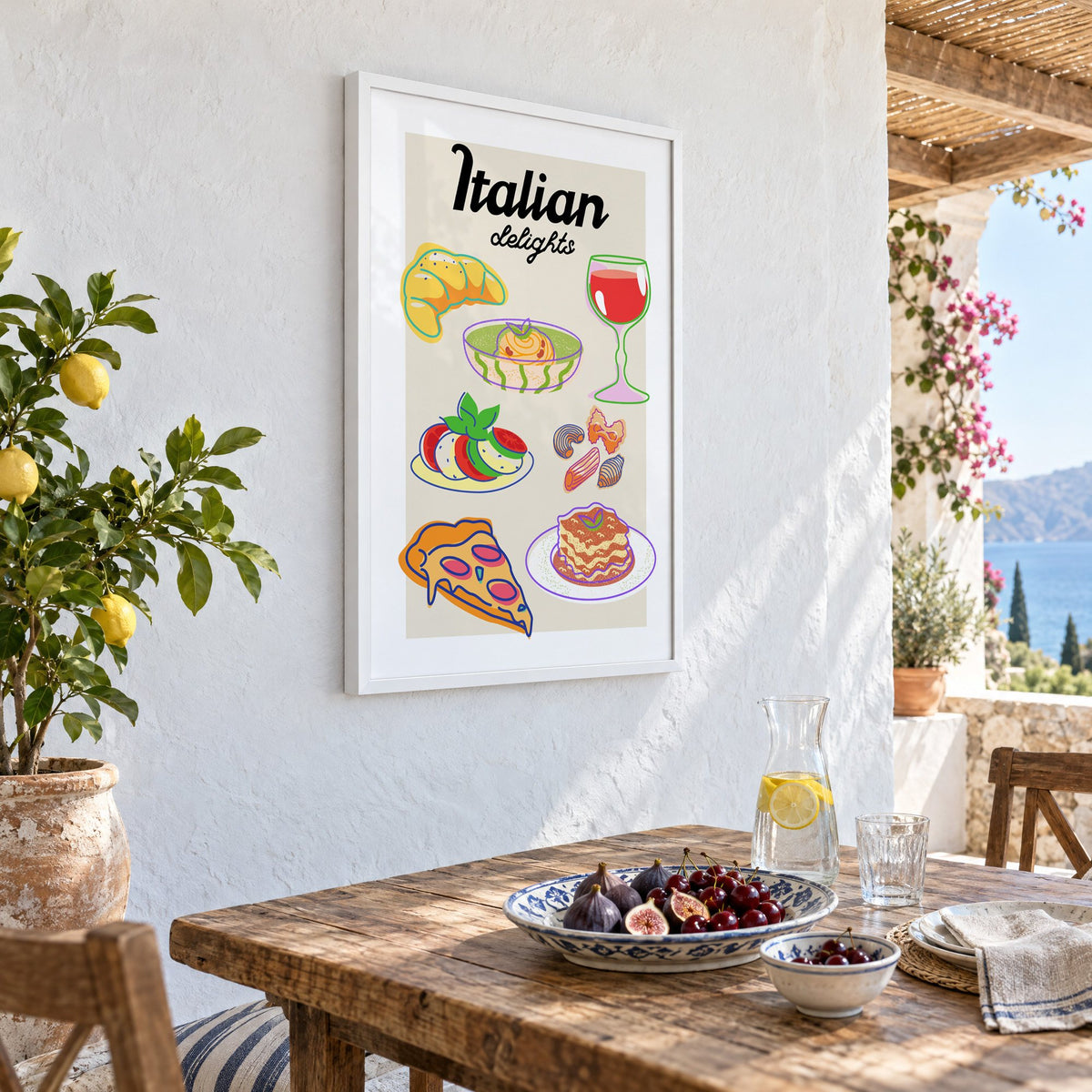 Italian delights colorful food doodle print in a white frame on a whitewashed terrace wall above a lunch table with figs and cherries, seen at an angle