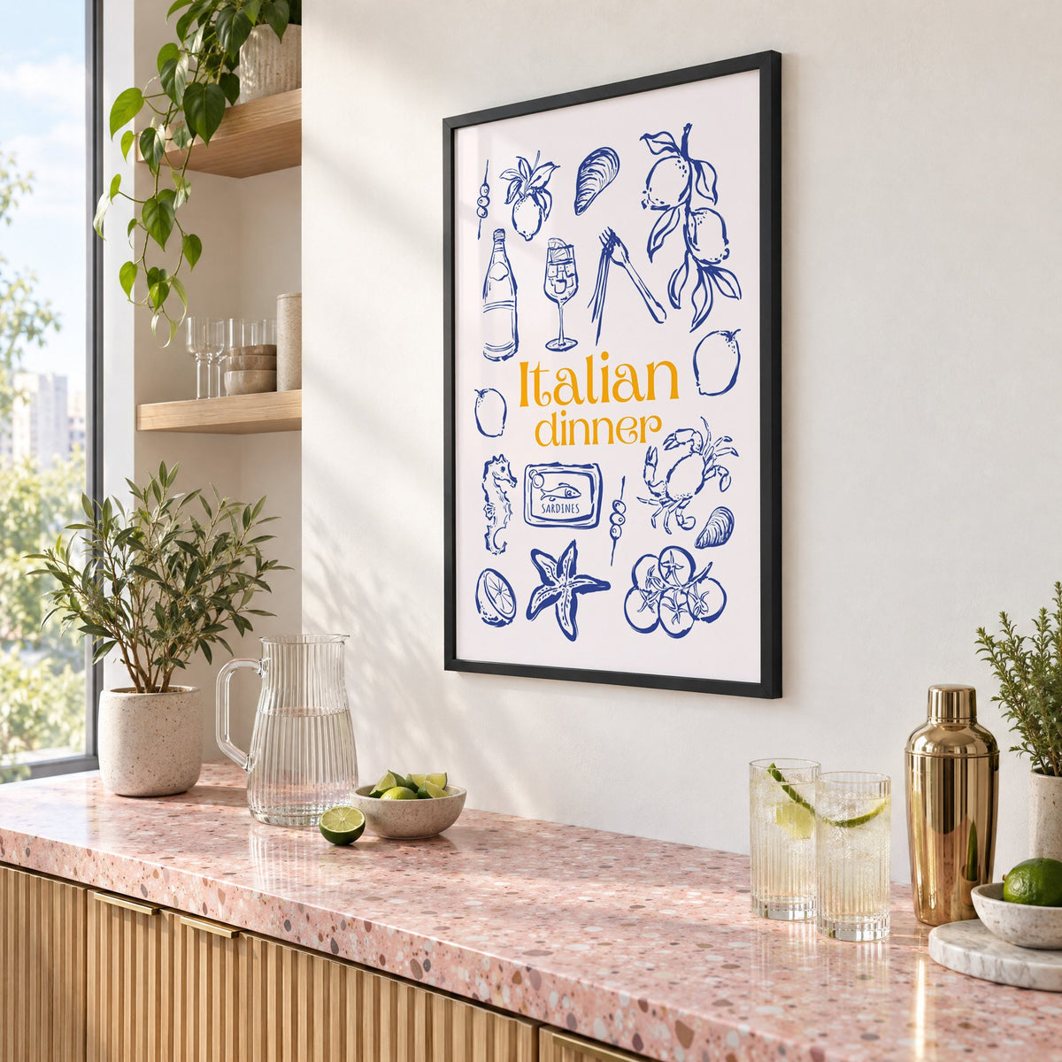 Italian dinner blue doodle print in a black frame above a pink terrazzo cocktail counter with limes, seen at an angle