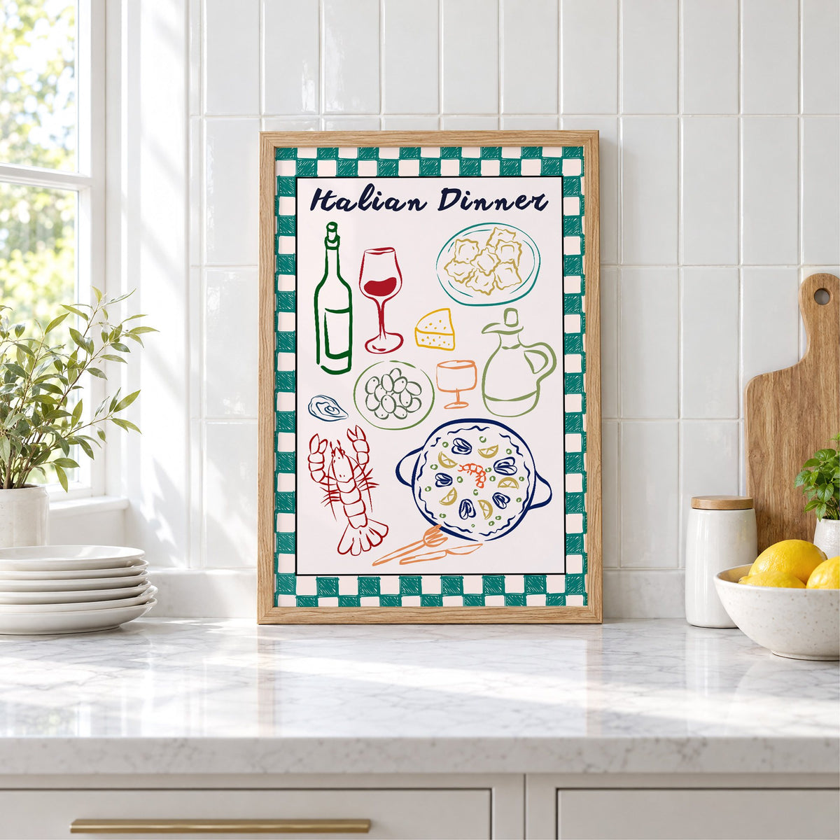 Italian Dinner gingham doodle print in an oak frame leaning on a marble counter by white tiles and lemons