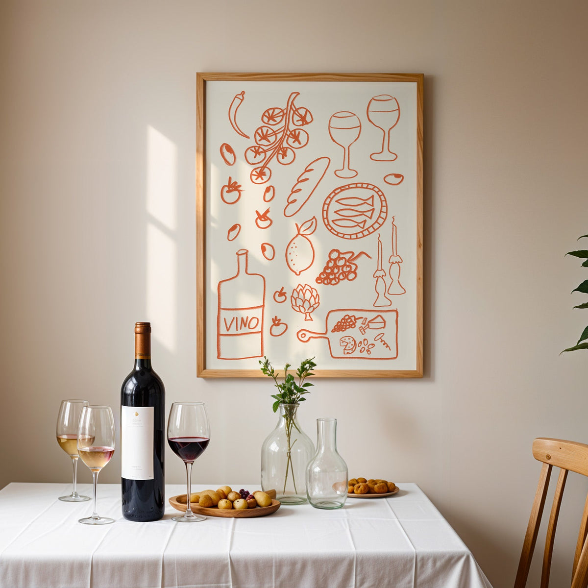 Italian pantry doodle print in an oak frame above a table laid with red wine and glasses