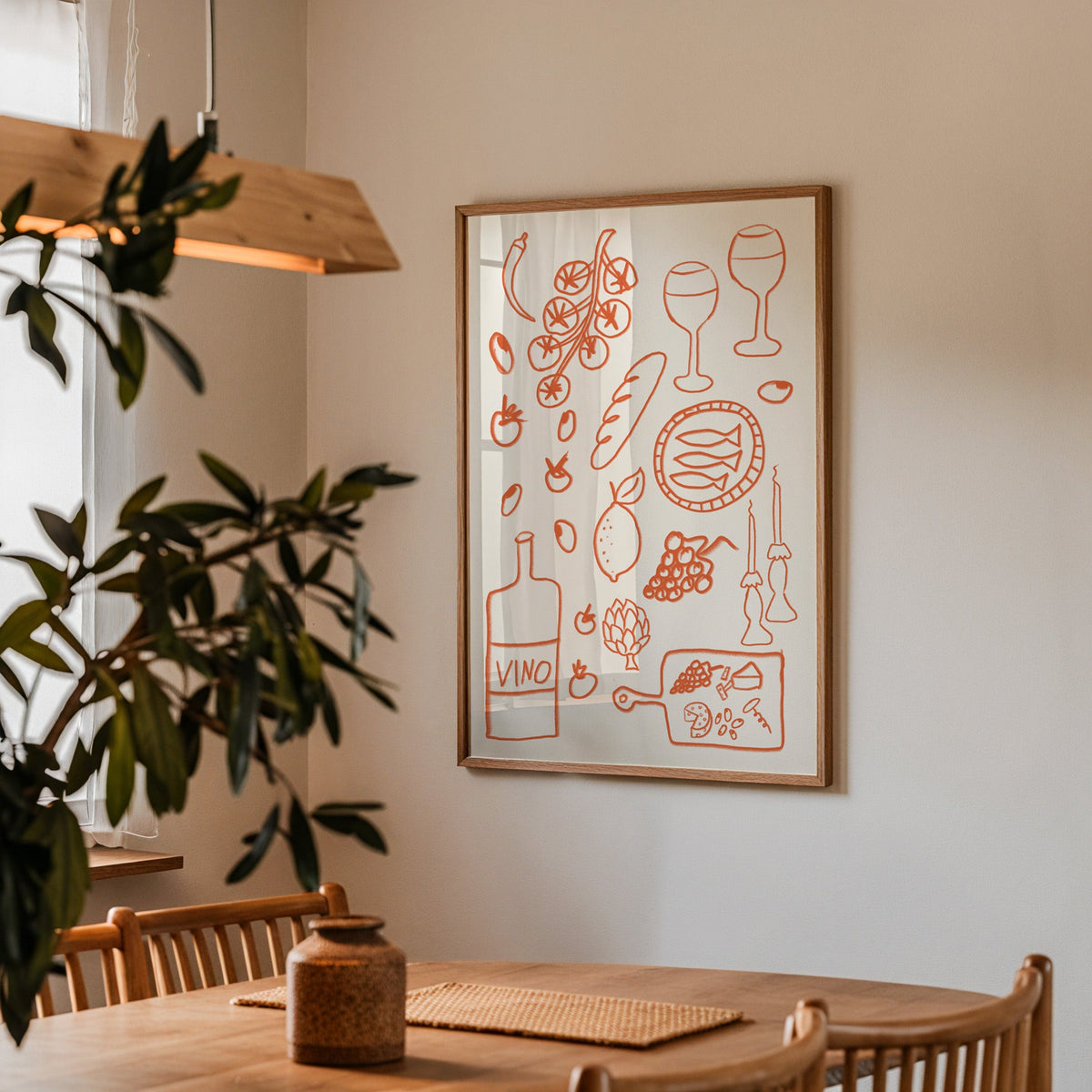 Italian pantry doodle print in a walnut frame above a dining table beside an olive tree