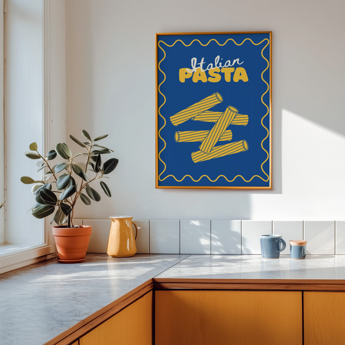 Navy rigatoni print in a gold frame above a marble counter with a yellow ceramic jug