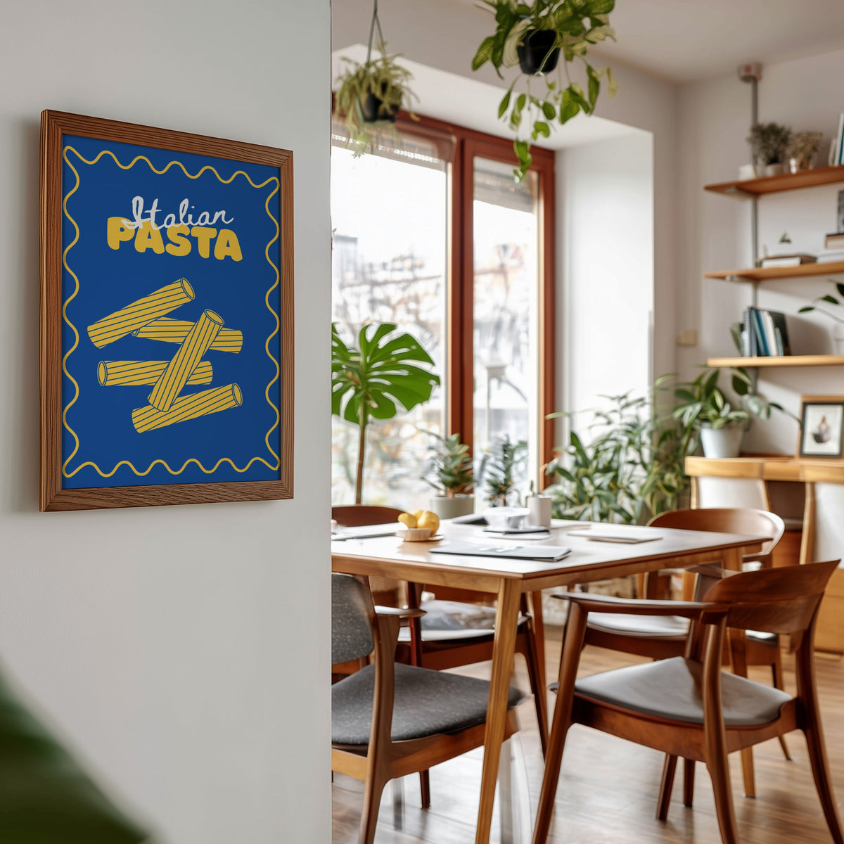 Navy rigatoni print in a walnut frame beside a mid-century dining table