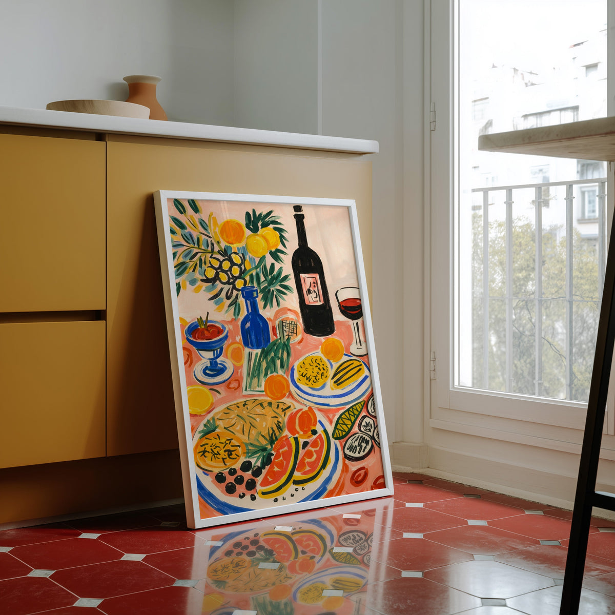 Italian table print in a white frame against yellow cabinets on a red tiled floor