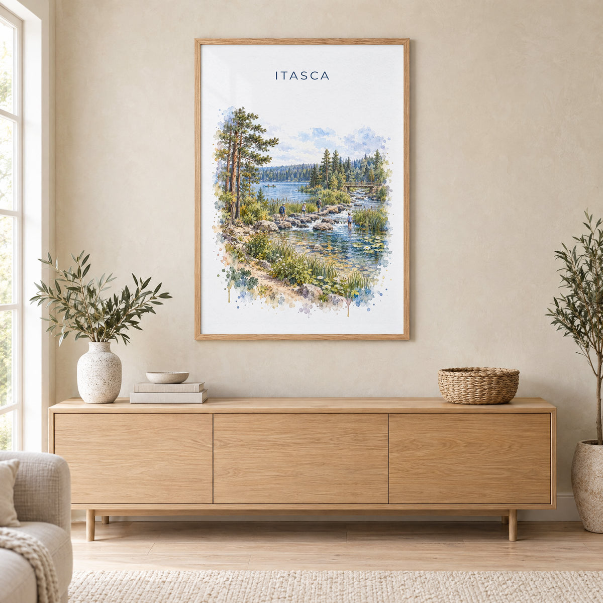 Itasca State Park watercolor print in an oak frame above a light wood sideboard in a Scandinavian living room