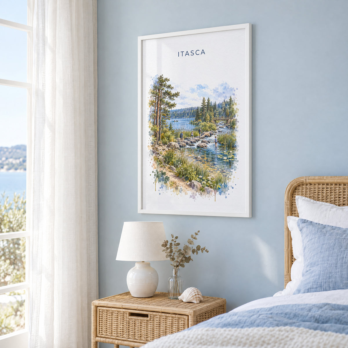 Itasca State Park watercolor print in a white frame on a pale blue wall beside a rattan bed in a coastal bedroom