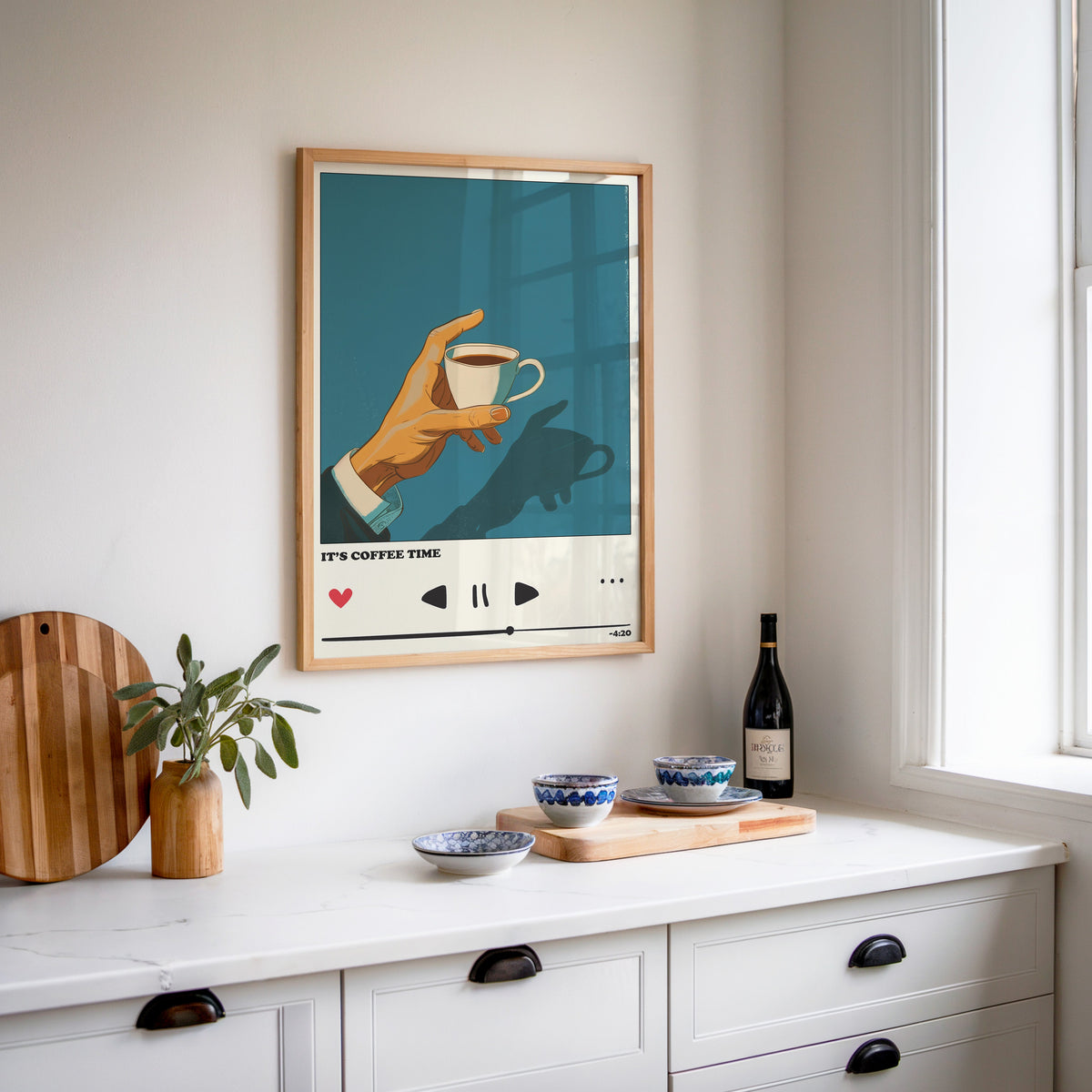 It's Coffee Time print in an oak frame above a white sideboard with a bottle of wine