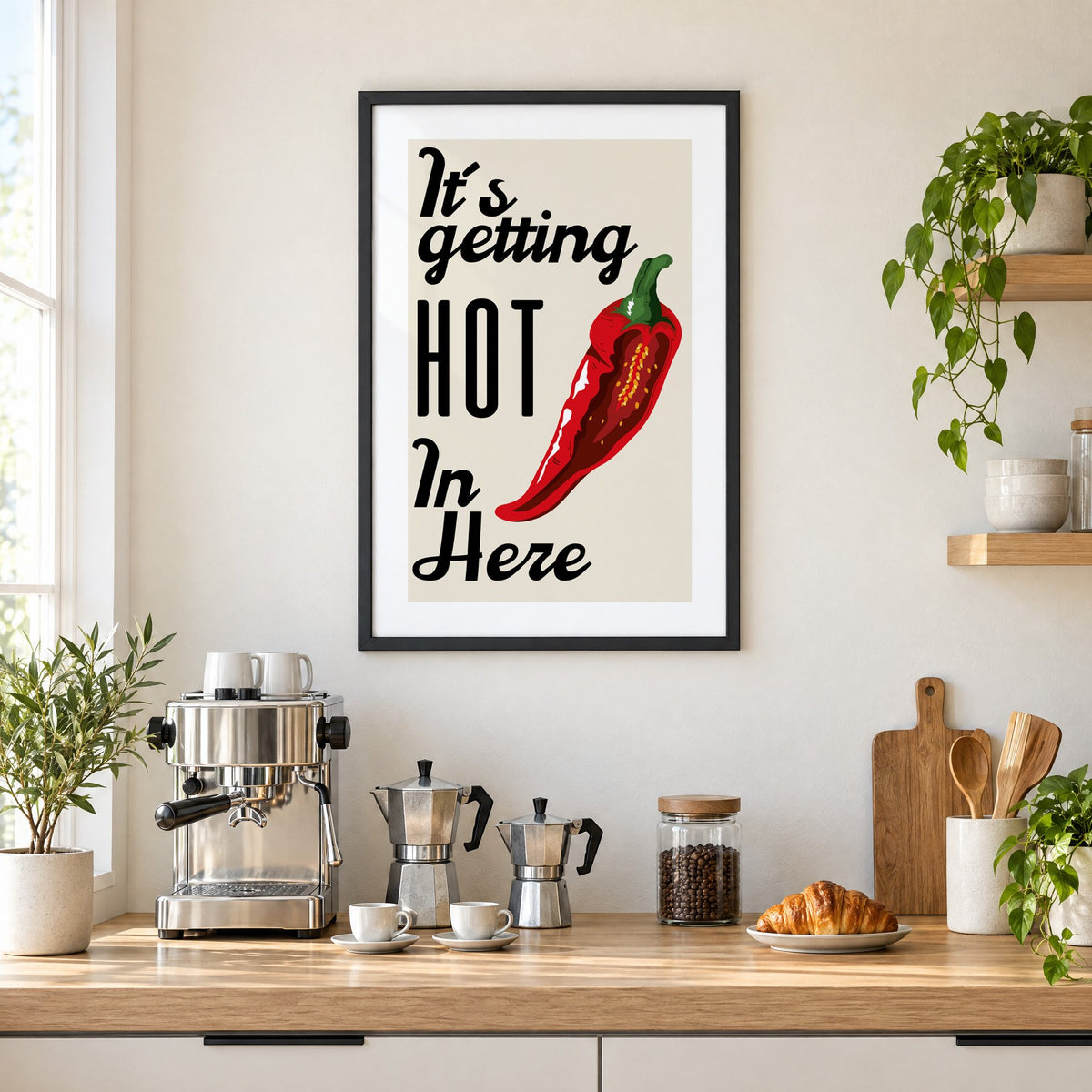 It's getting HOT In Here split chili print in a black frame above a home espresso bar with moka pots and espresso cups