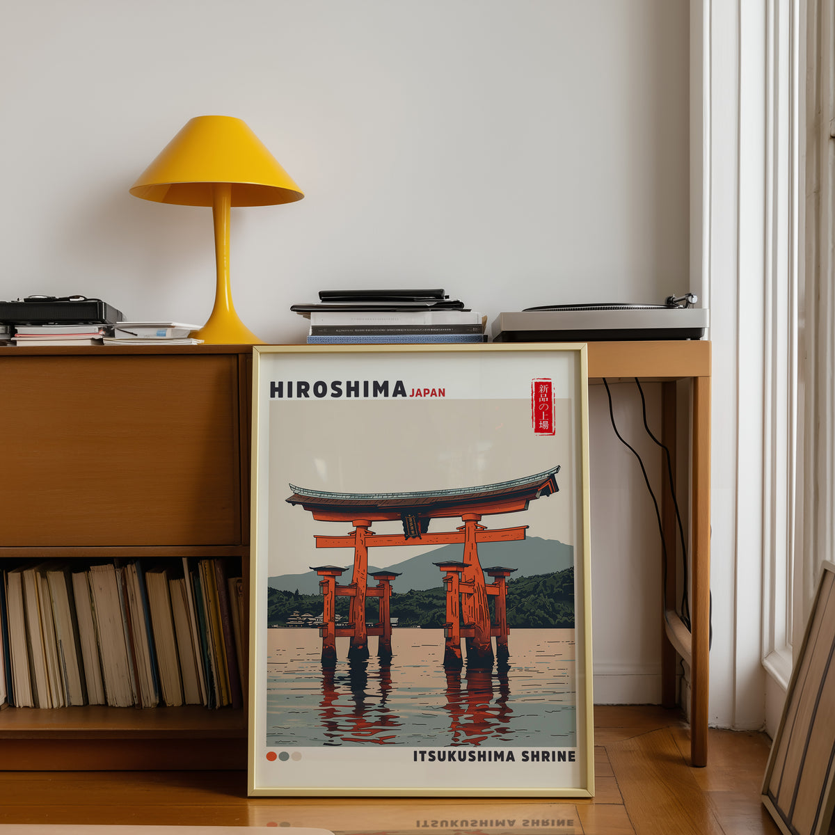 Retro Itsukushima torii gate print shown in a gold frame below a teak desk with a yellow lamp