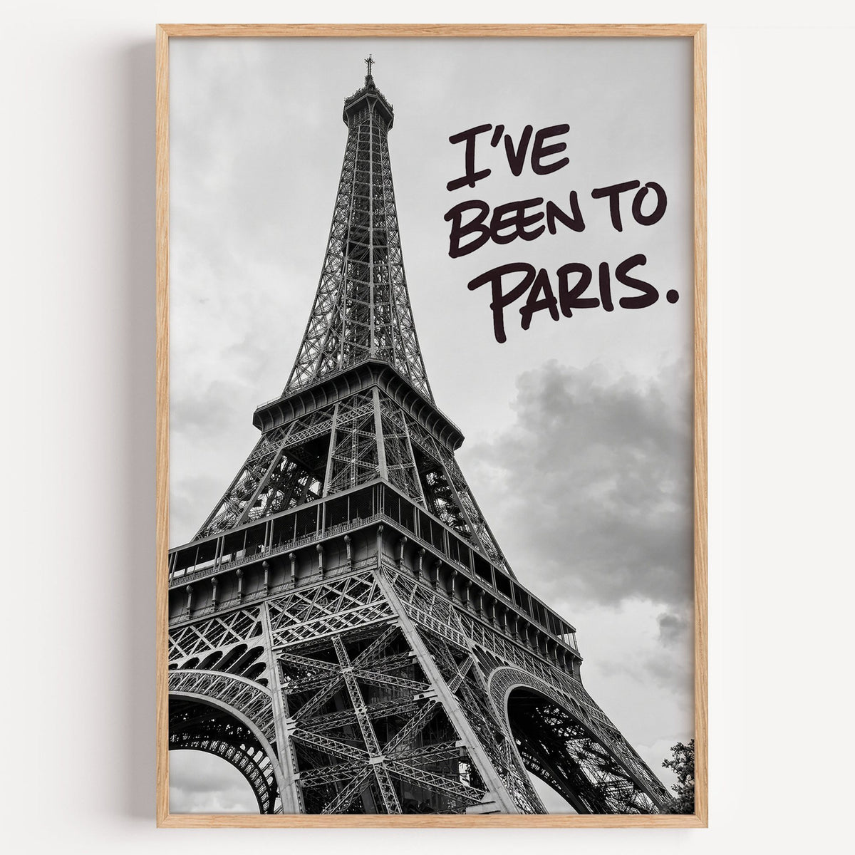 I've Been to Paris handwritten quote on Eiffel photo print in a light oak frame on a plain white wall
