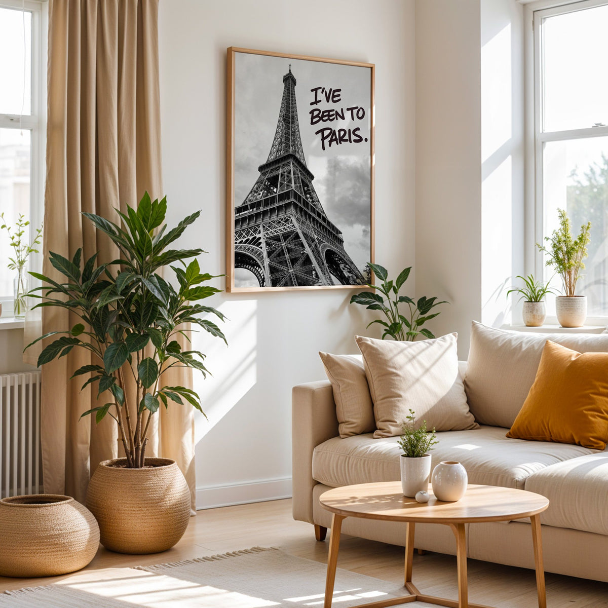 I've Been to Paris handwritten quote on Eiffel photo print in an oak frame above a cream sofa beside woven planters