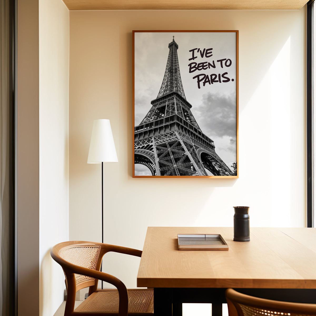 I've Been to Paris handwritten quote on Eiffel photo print in an oak frame above a dining table and cane chair