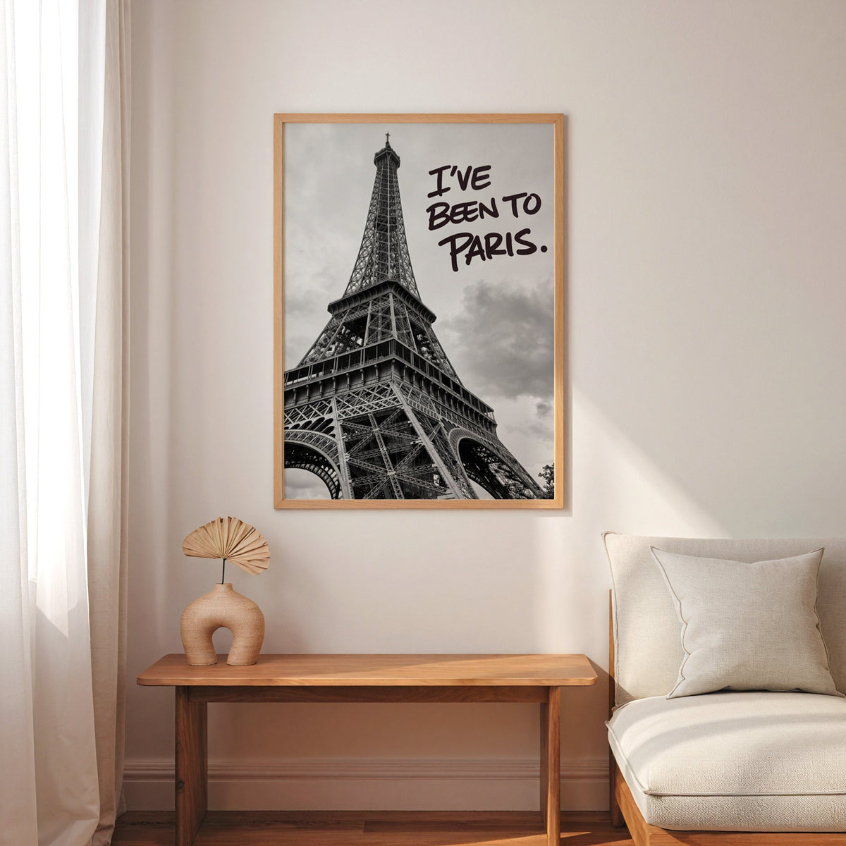 I've Been to Paris handwritten quote on Eiffel photo print in an oak frame above a narrow console with an arched vase