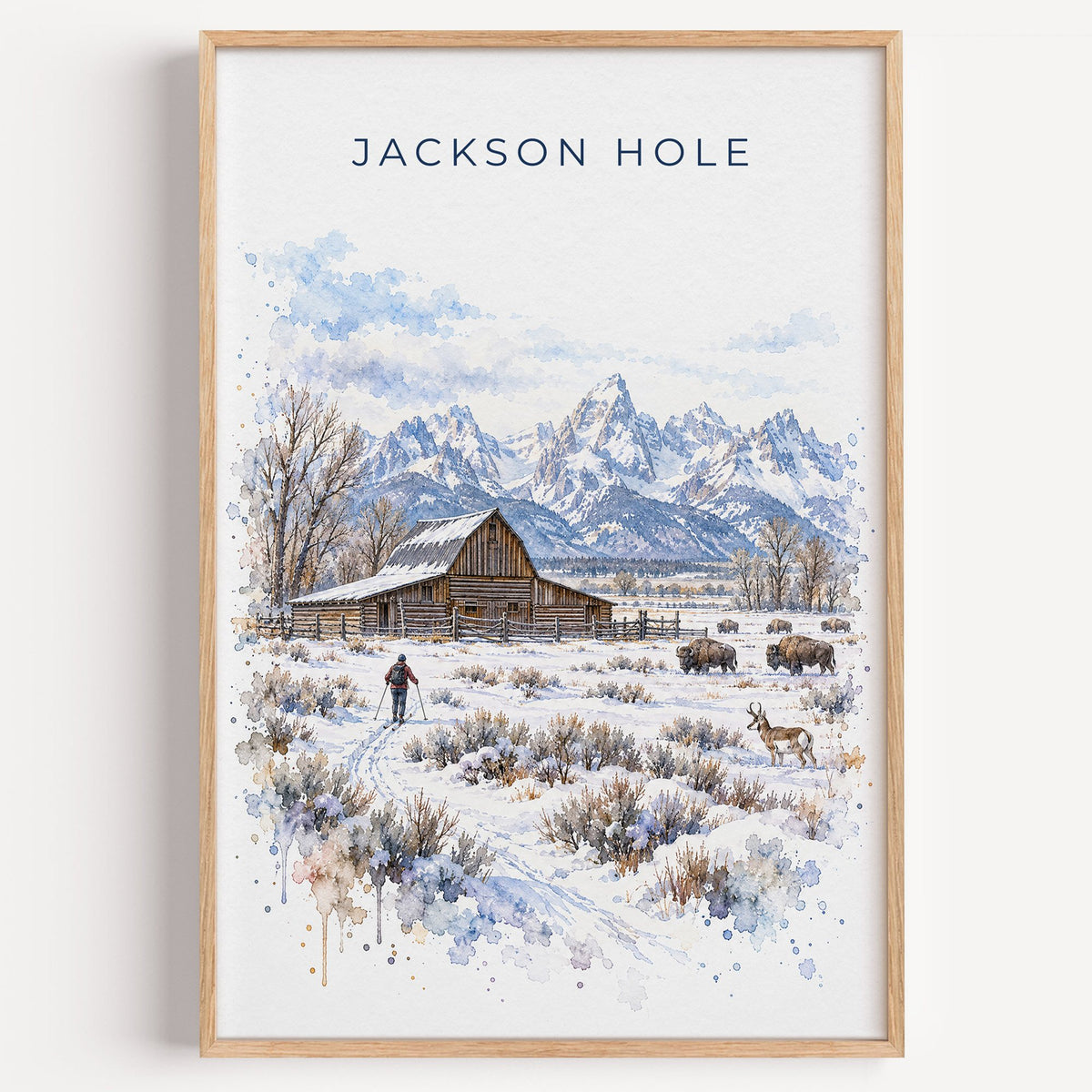 Jackson Hole watercolor print in a light oak frame on a plain white wall