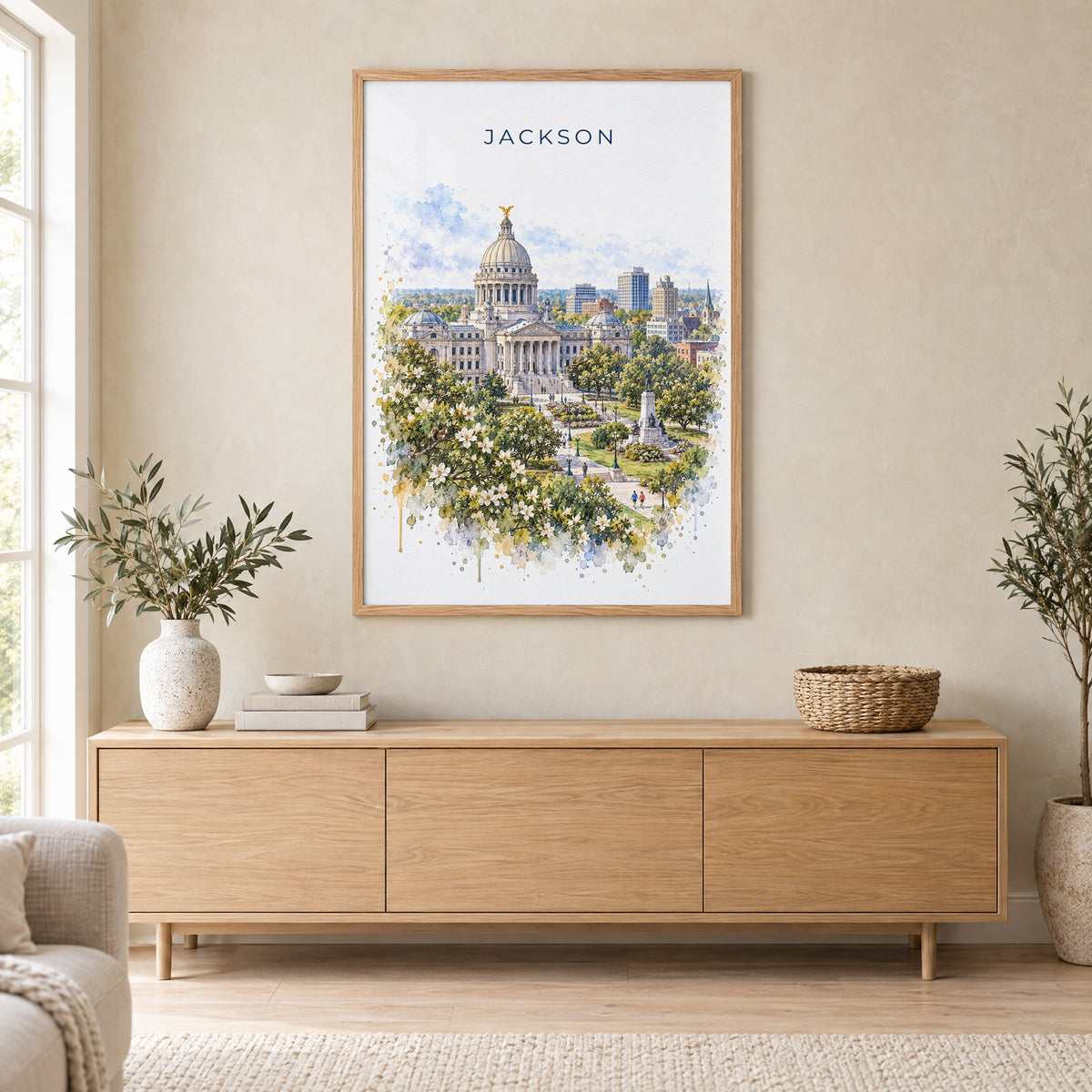 Jackson, Mississippi watercolor print in an oak frame above a light wood sideboard in a Scandinavian living room